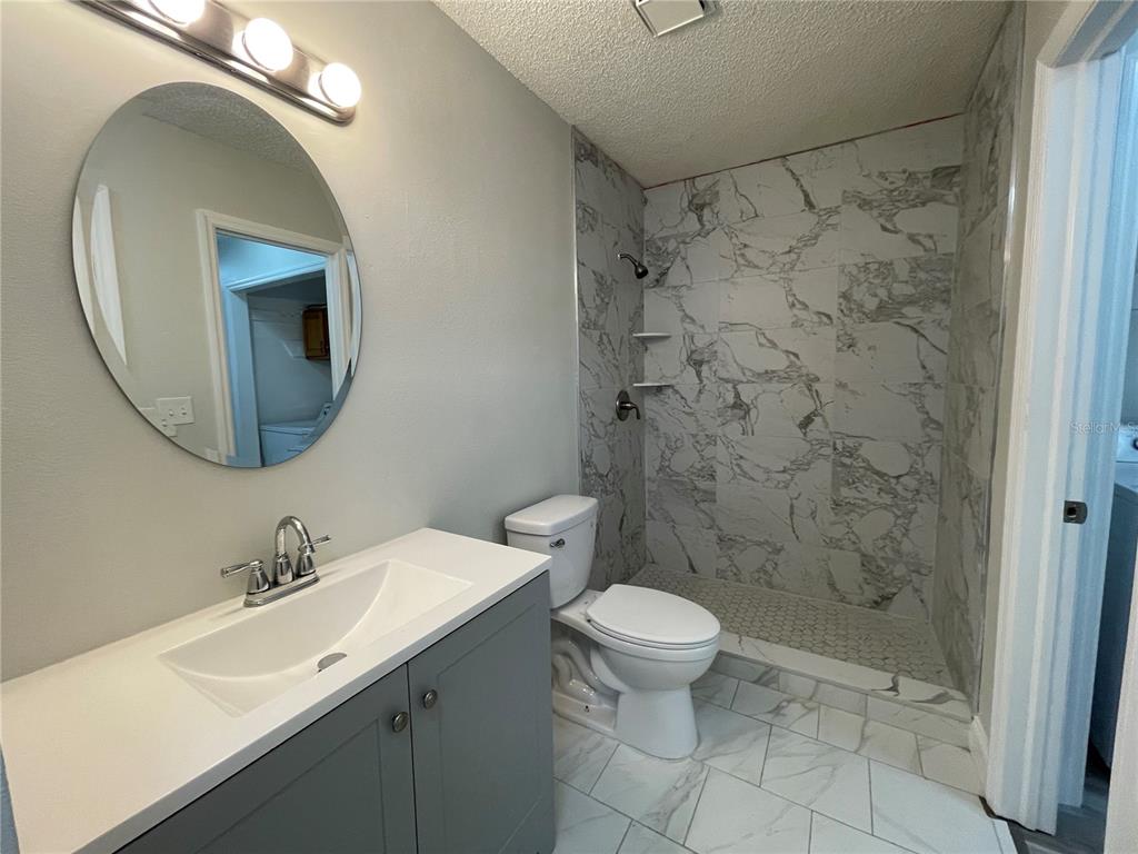 1600 Big Tree Road, Unit H3 South Daytona, FL 32119 - Photo 10 of 18 a bathroom with a sink a toilet and shower