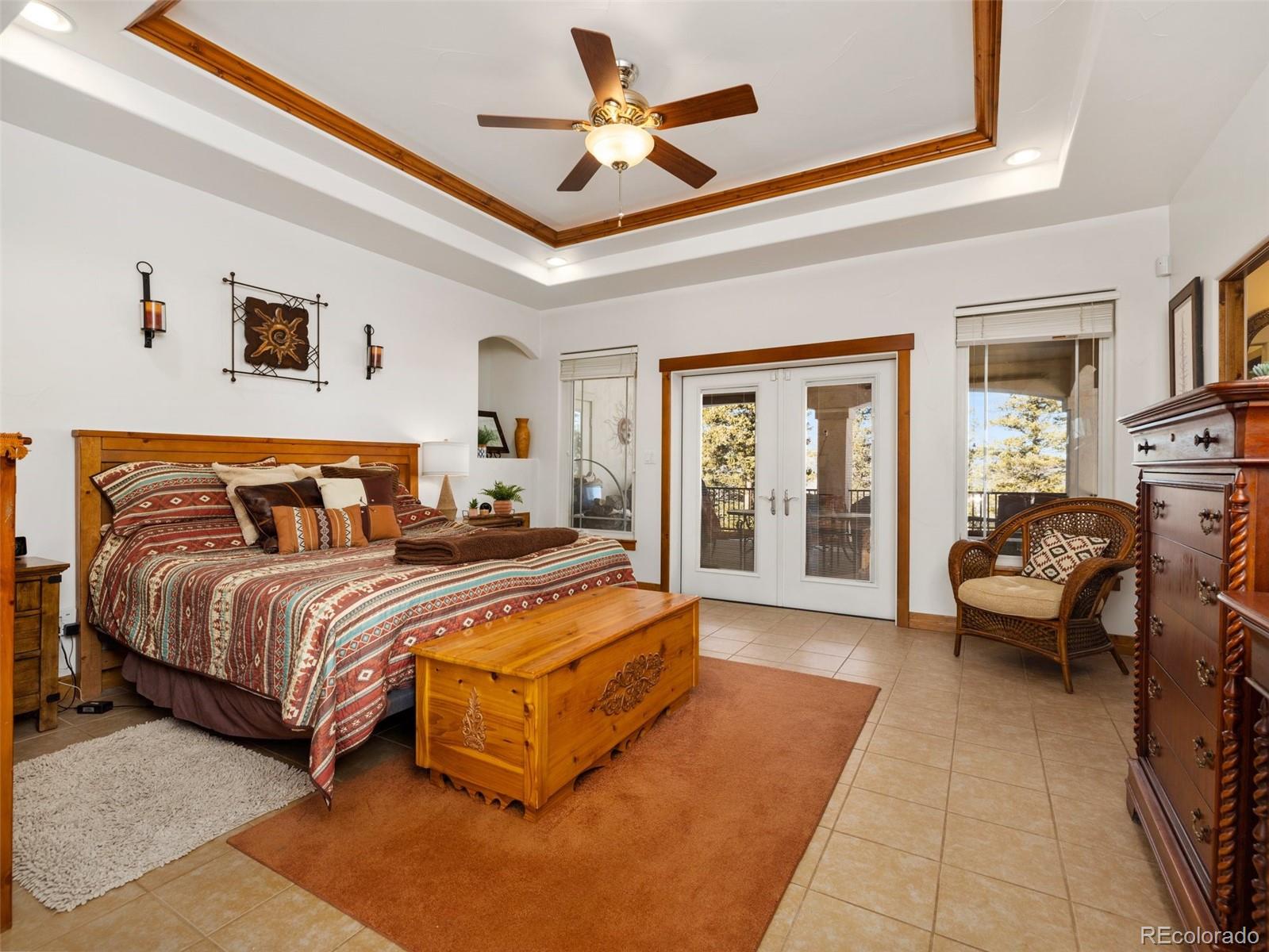 8760 Ridge Road Beulah, CO 81023 - Photo 19 of 33 a spacious bedroom with a bed couch and a window