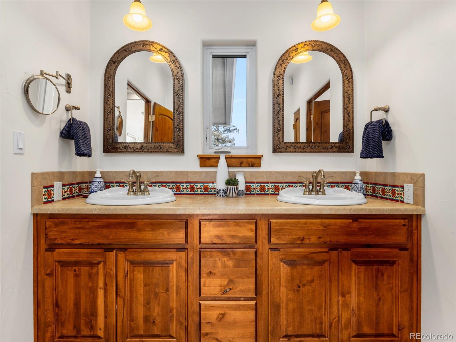8760 Ridge Road Beulah, CO 81023 - Photo 24 of 33 a bathroom with 2 sink and a mirror
