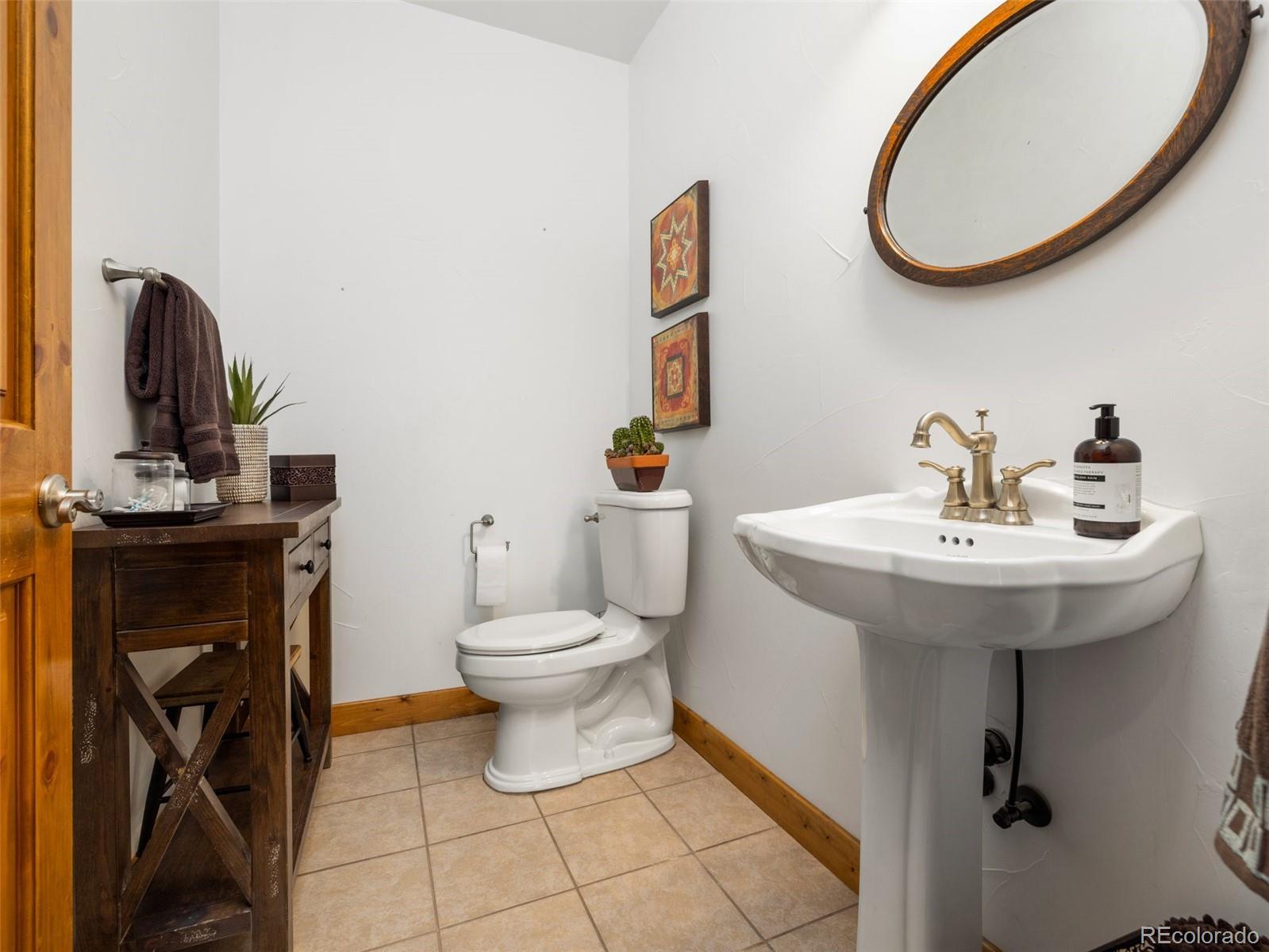 8760 Ridge Road Beulah, CO 81023 - Photo 27 of 33 a bathroom with a toilet sink and mirror