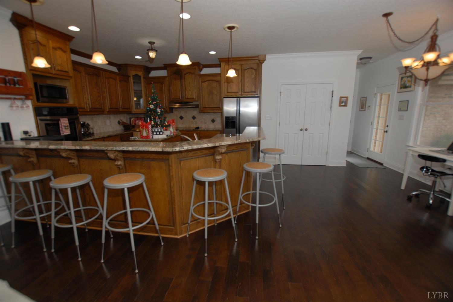 1669 Matthew Talbot Road Forest, VA 24551 - Photo 3 of 56 a kitchen with a dining table chairs stainless steel appliances and cabinets
