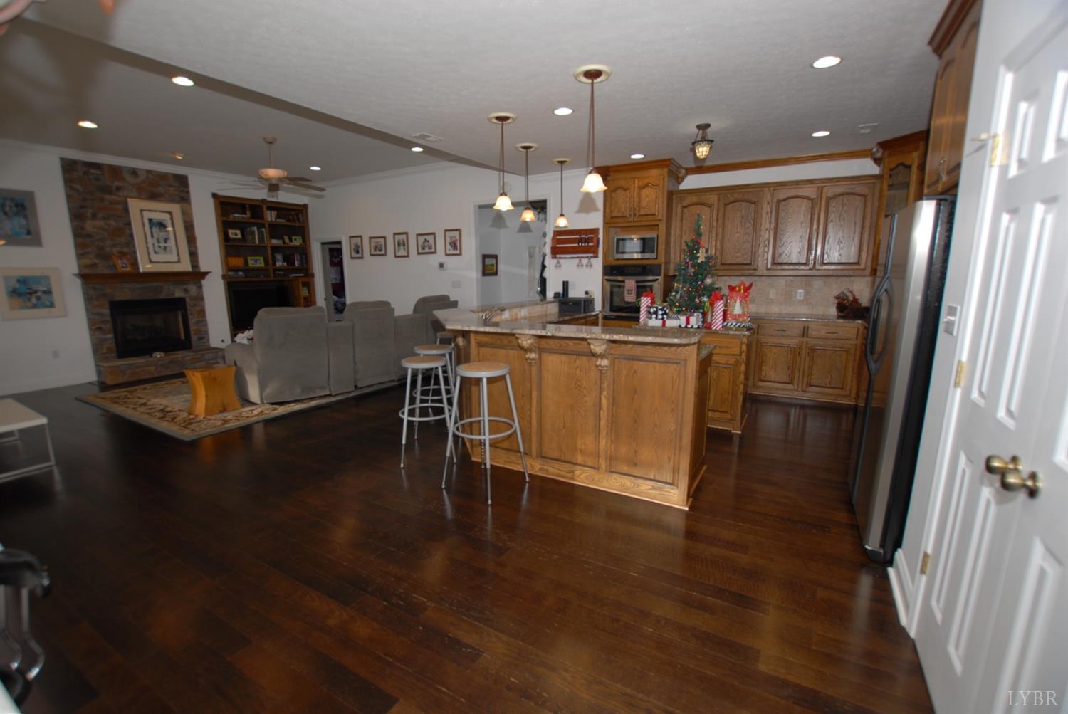 1669 Matthew Talbot Road Forest, VA 24551 - Photo 53 of 56 a living room with stainless steel appliances kitchen island granite countertop furniture wooden floor and a view of kitchen