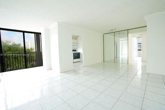 17021 North Bay Road, Unit 414 Sunny Isles Beach, FL 33160 - Photo 5 of 28 a view of empty room with wooden floor