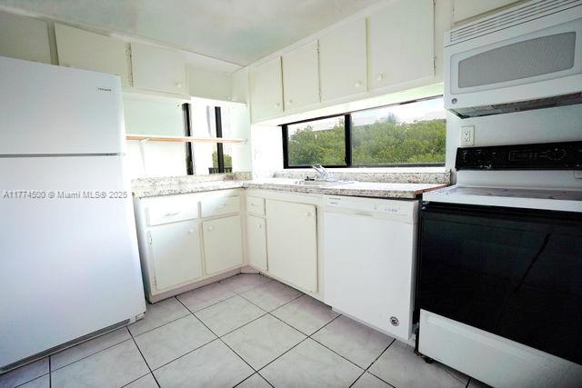 17021 North Bay Road, Unit 414 Sunny Isles Beach, FL 33160 - Photo 10 of 28 a kitchen with a sink cabinets and window