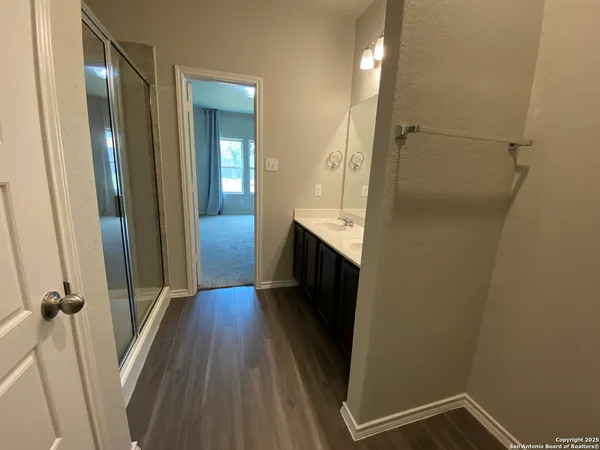 a view of hallway with wooden floor