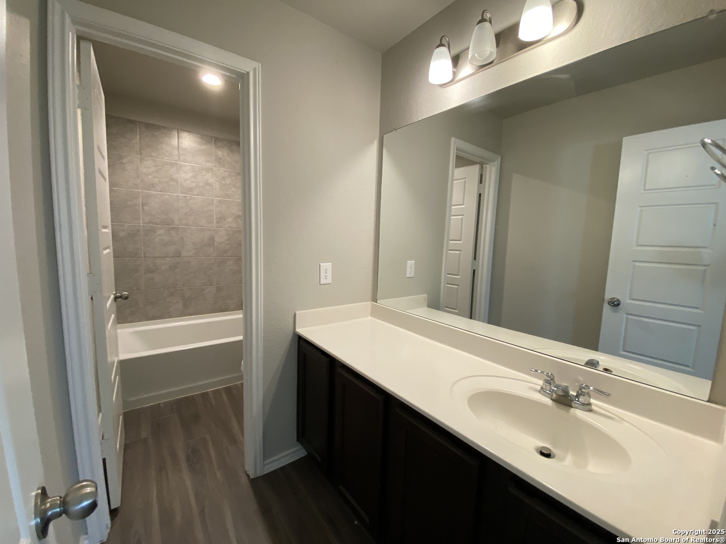 10822 Randolph Way Converse, TX 78109 - Photo 25 of 33 a bathroom with a sink a shower and a mirror