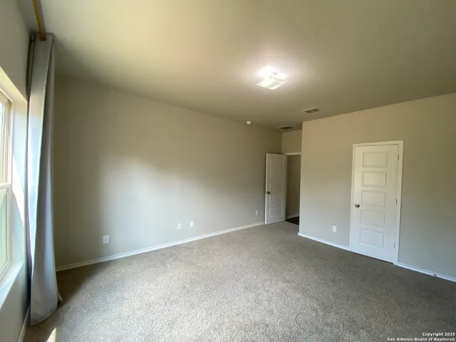 an empty room with a empty space and windows