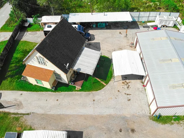 aerial view of residential house with outdoor space and seating area