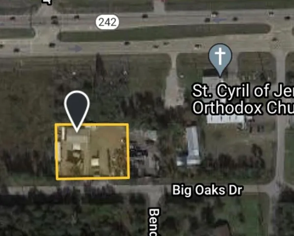 an aerial view of a house with a yard and lake view