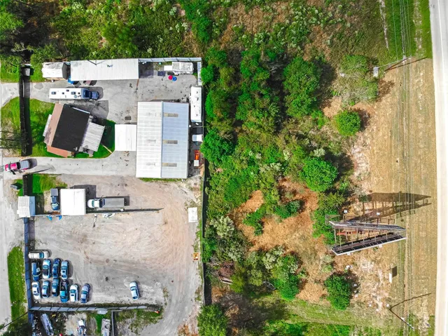 a view of a white house with a yard porch and outdoor seating