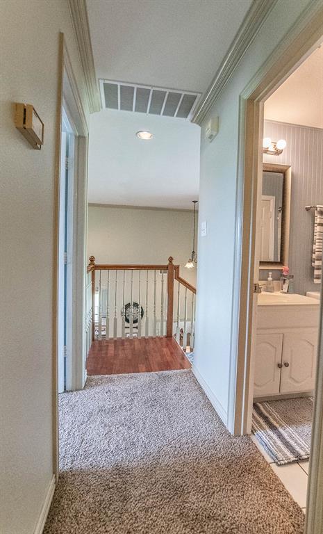 10336 Jennifer Circle Forney, TX 75126 - Photo 27 of 37 This is a view looking down the hallway of the guest bedrooms into the living area below. The guest bath is to the right.