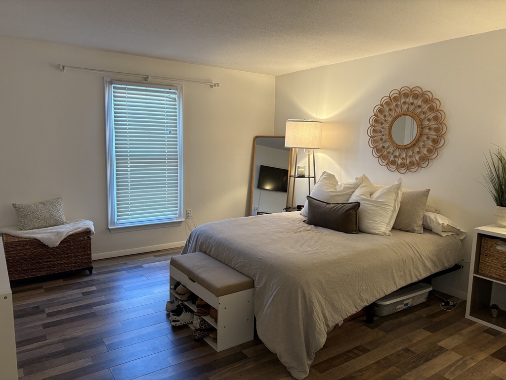 8 Shadowbrook Lane, Unit 14 Milford, MA 01757 - Photo 11 of 19 a bedroom with a bed and a chair