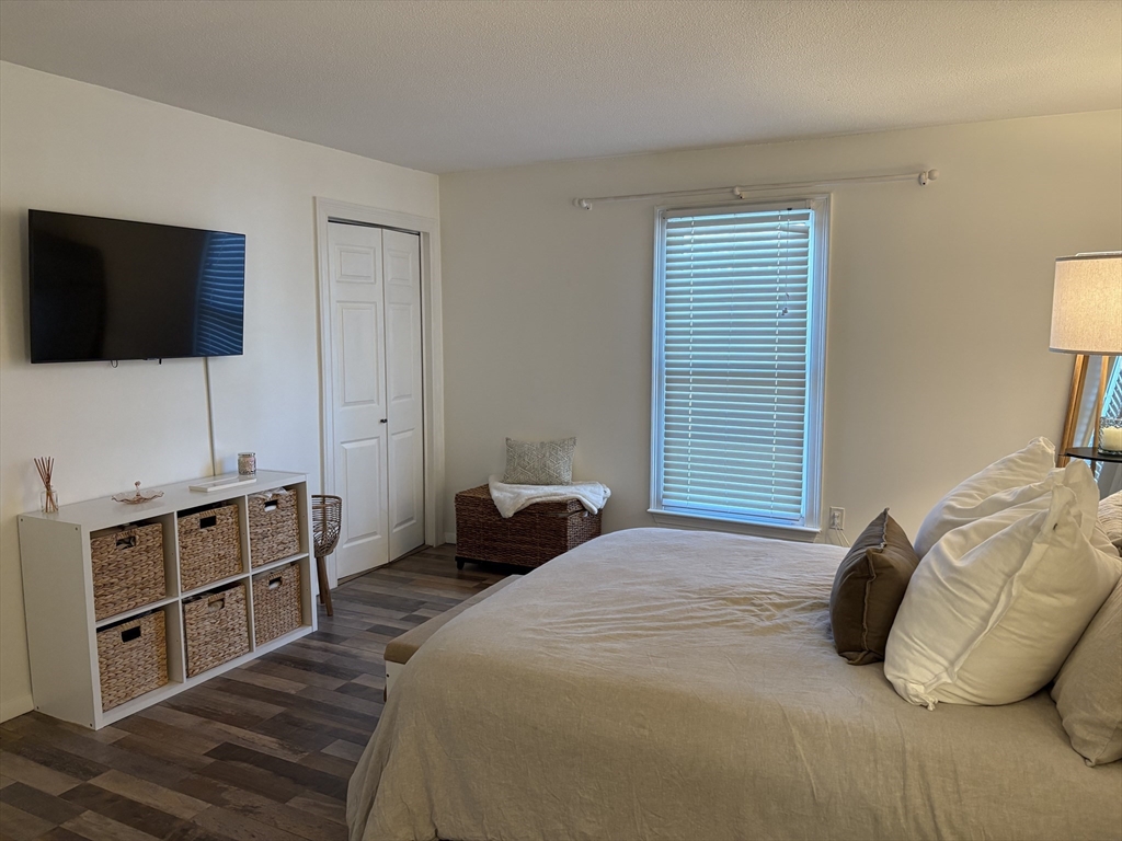8 Shadowbrook Lane, Unit 14 Milford, MA 01757 - Photo 13 of 19 a bedroom with a bed and a flat screen tv