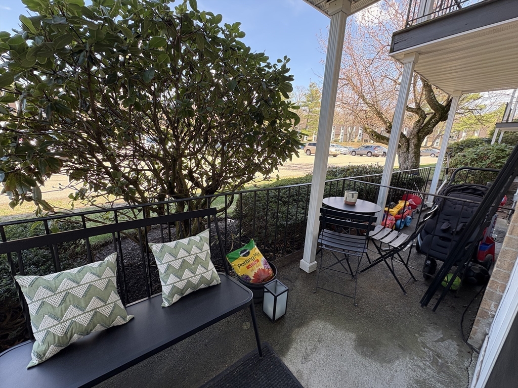 8 Shadowbrook Lane, Unit 14 Milford, MA 01757 - Photo 16 of 19 a outdoor living space with furniture and a potted plant