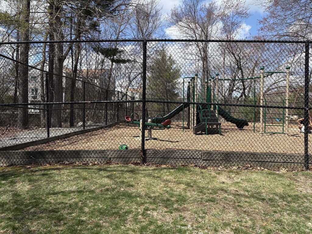 8 Shadowbrook Lane, Unit 14 Milford, MA 01757 - Photo 18 of 19 a view of a backyard