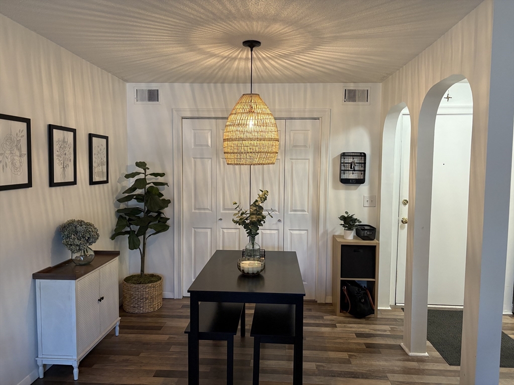 8 Shadowbrook Lane, Unit 14 Milford, MA 01757 - Photo 2 of 19 a dining room with chandelier and wooden floor