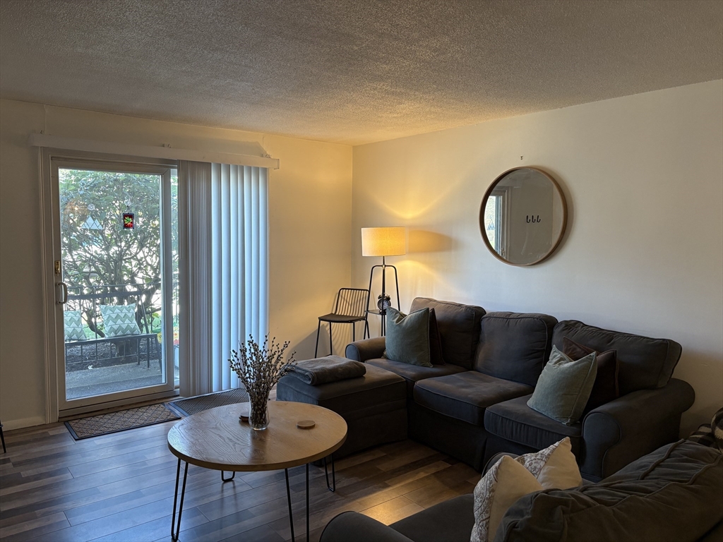 8 Shadowbrook Lane, Unit 14 Milford, MA 01757 - Photo 4 of 19 a living room with furniture and a window