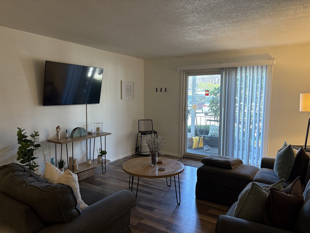 8 Shadowbrook Lane, Unit 14 Milford, MA 01757 - Photo 5 of 19 a living room with furniture and a flat screen tv