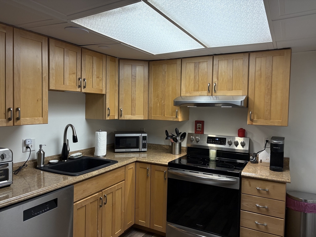8 Shadowbrook Lane, Unit 14 Milford, MA 01757 - Photo 8 of 19 a kitchen with granite countertop a sink cabinets and stainless steel appliances