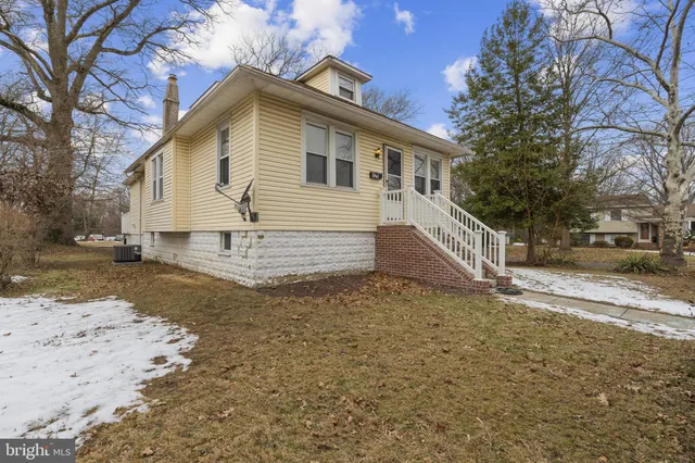 a view of a house with a yard covered in snow