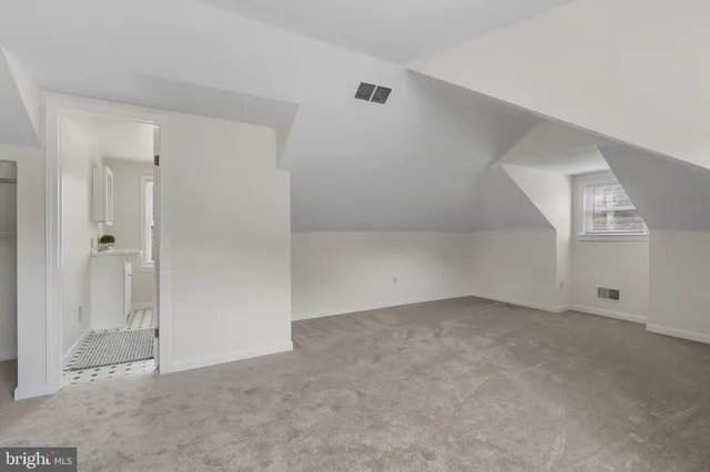 a bathroom with a sink toilet and a window