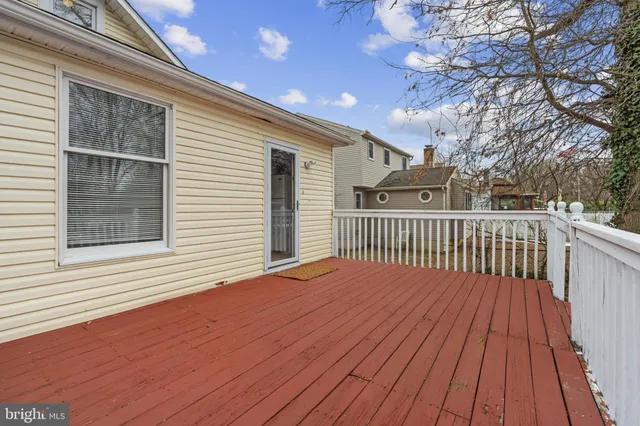 a view of a white house with a yard covered in snow