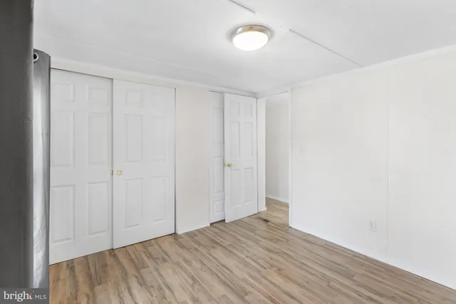 a view of an empty room and wooden floor