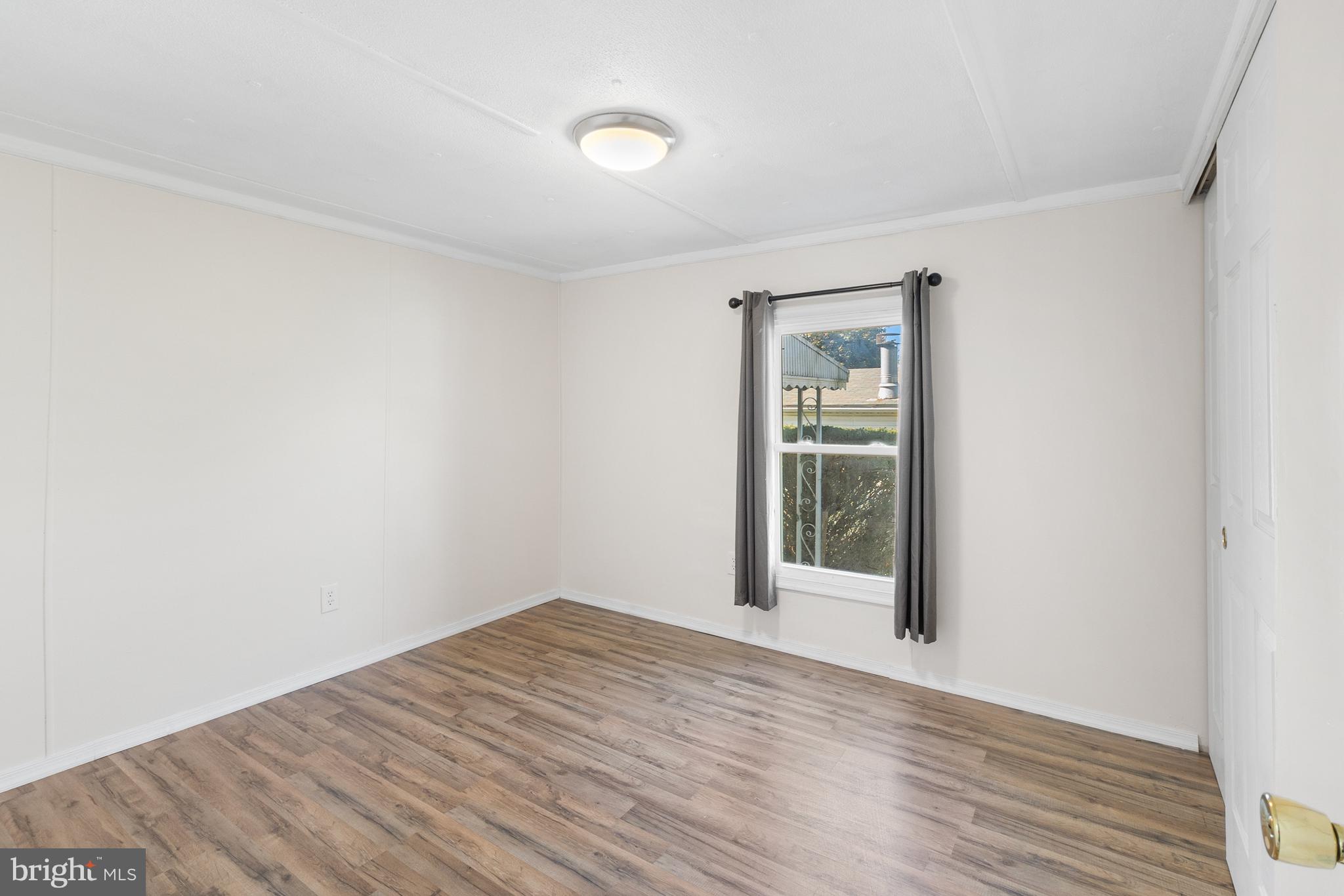 2 Westview Way West Grove, PA 19390 - Photo 18 of 26 a view of an empty room with wooden floor and a window