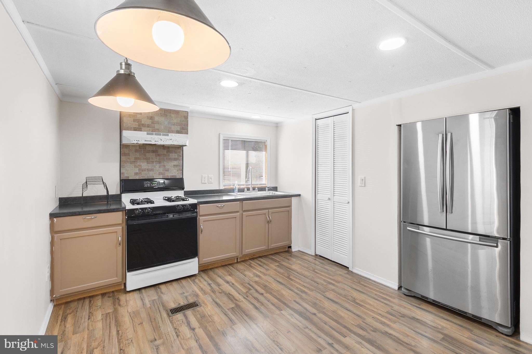 2 Westview Way West Grove, PA 19390 - Photo 19 of 26 a kitchen with stainless steel appliances granite countertop a stove a refrigerator and a wooden floors