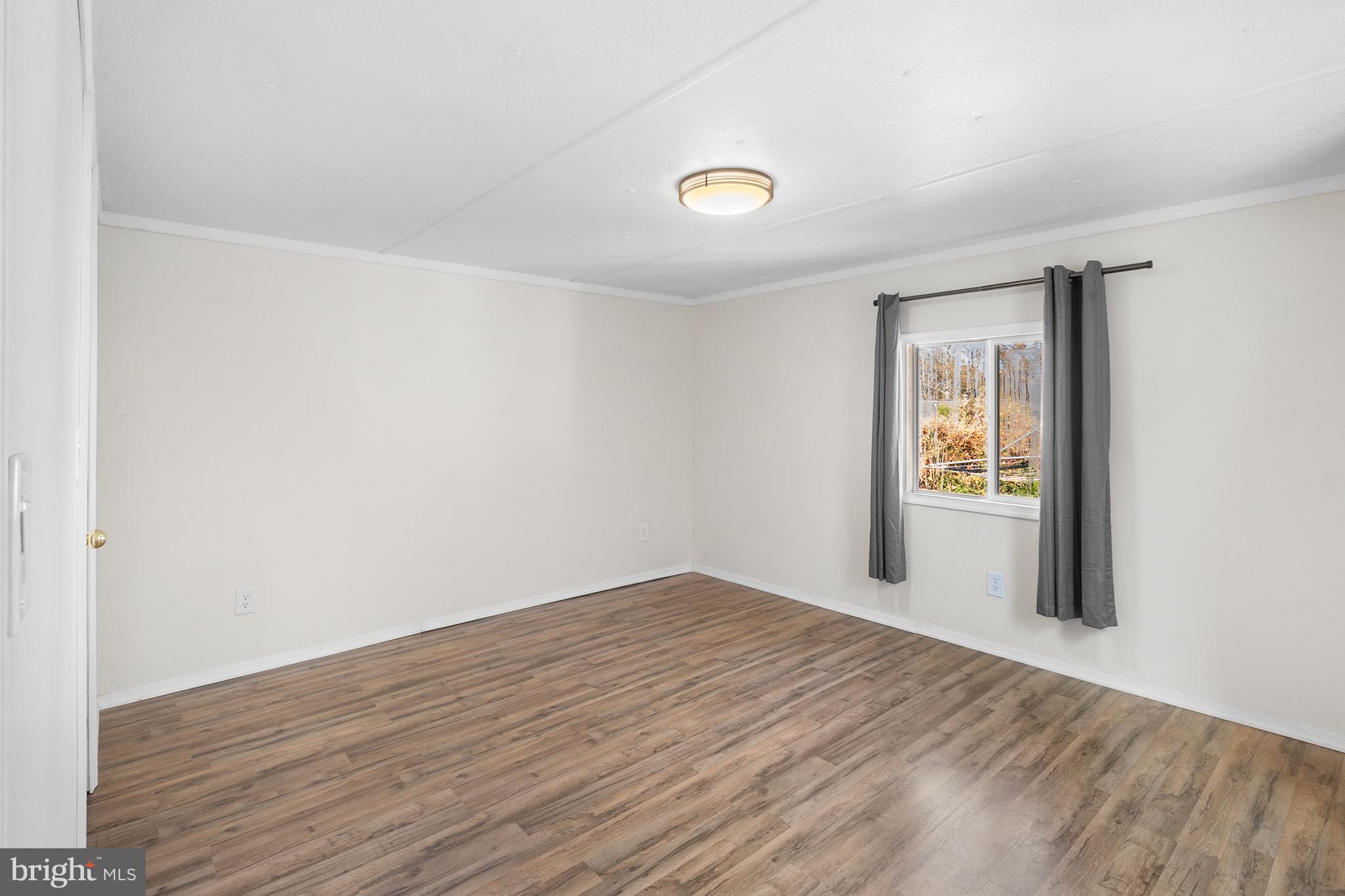 2 Westview Way West Grove, PA 19390 - Photo 5 of 26 a view of an empty room with wooden floor and a window