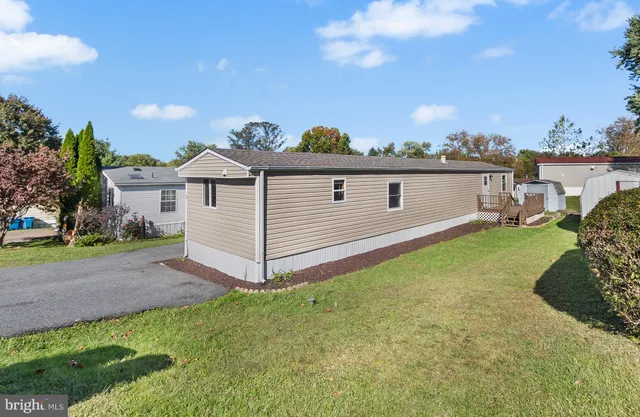 a front view of a house with a garden and yard