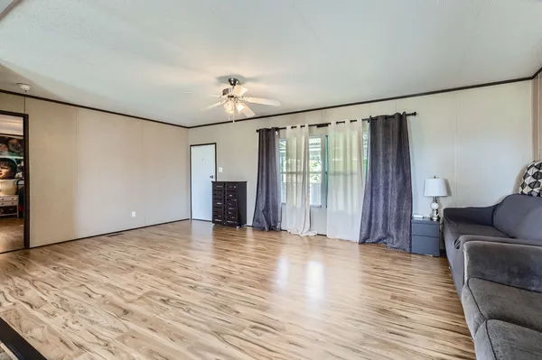 a view of livingroom with hardwood floor and ceiling fan