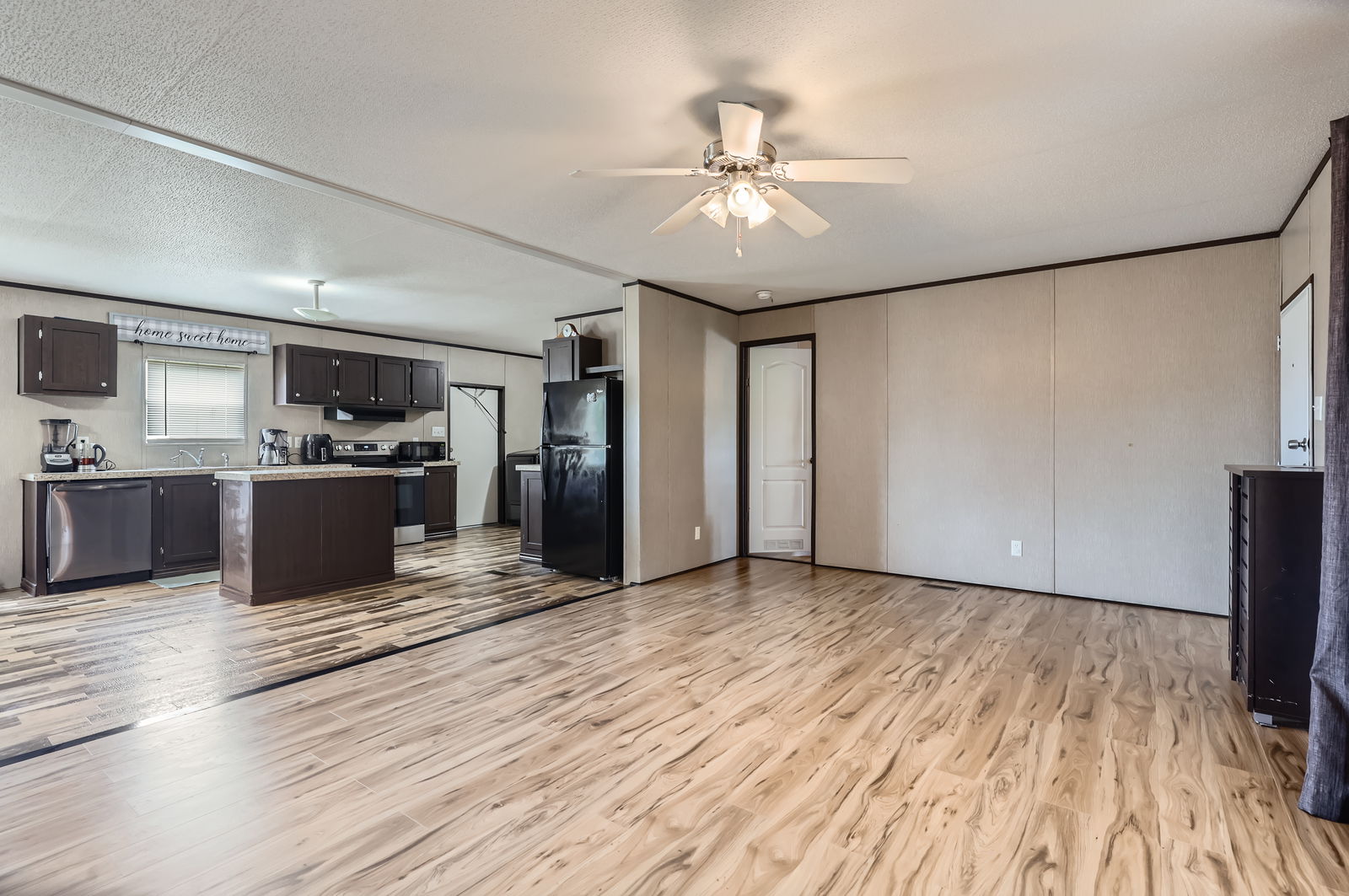 415 County Road 154 Georgetown, TX 78626 - Photo 16 of 28 Kitchen with stainless steel appliances, light countertops, light wood-style floors, ceiling fan, and ornamental molding