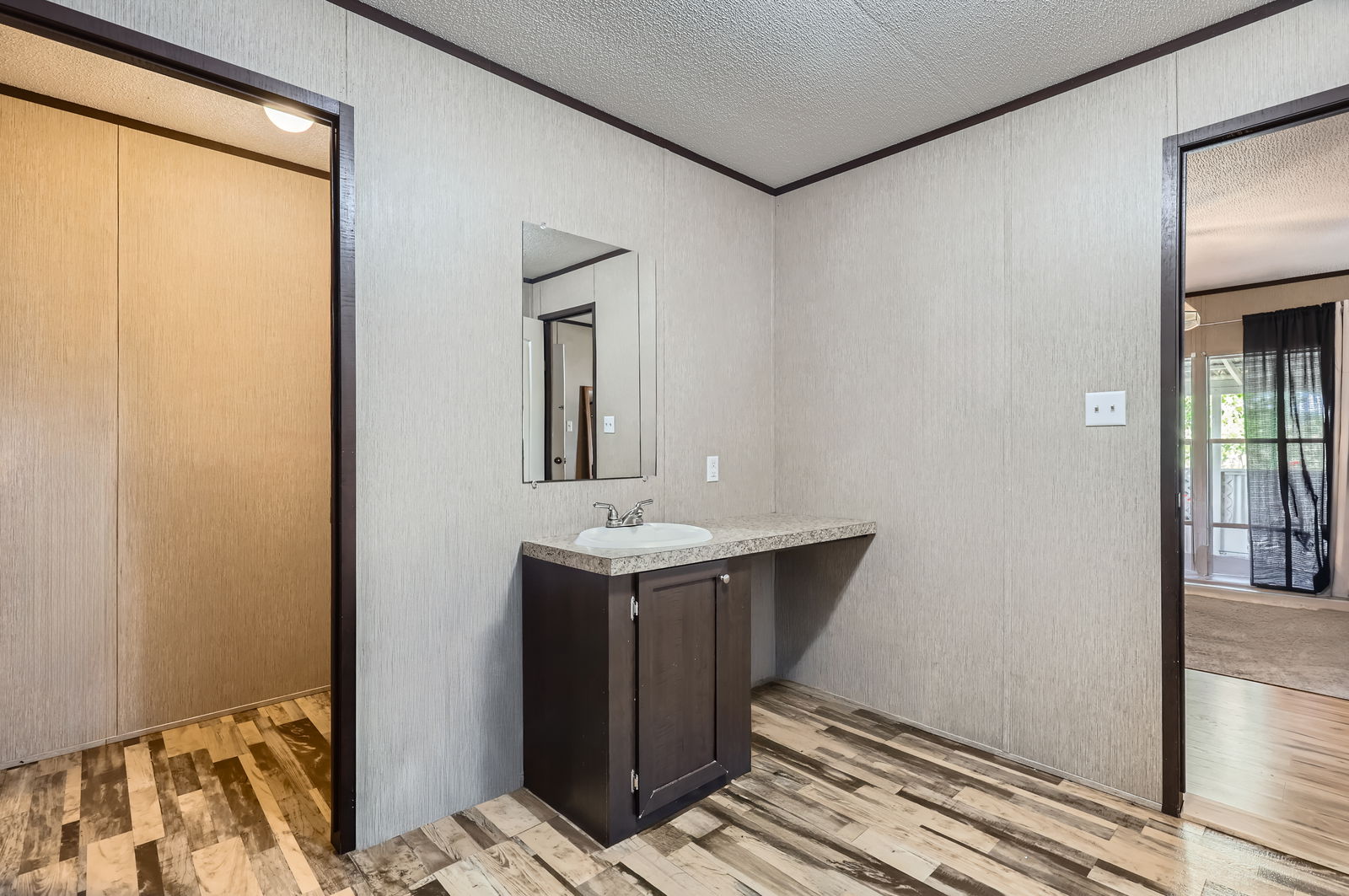 415 County Road 154 Georgetown, TX 78626 - Photo 20 of 28 Bathroom with ornamental molding, wood finished floors, vanity, and a textured ceiling