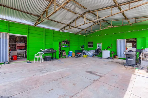 a view of a garage and a table under an umbrella