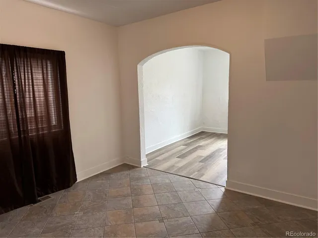 an empty room with wooden floor and cabinet
