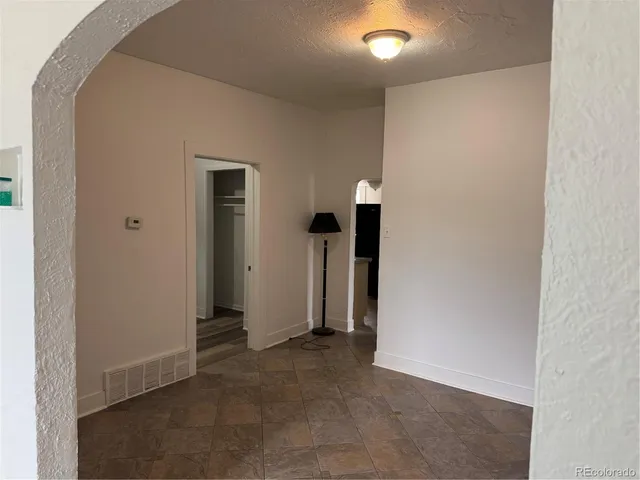 an empty room with closet and a mirror