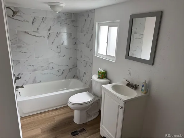 a bathroom with a sink toilet and bathtub