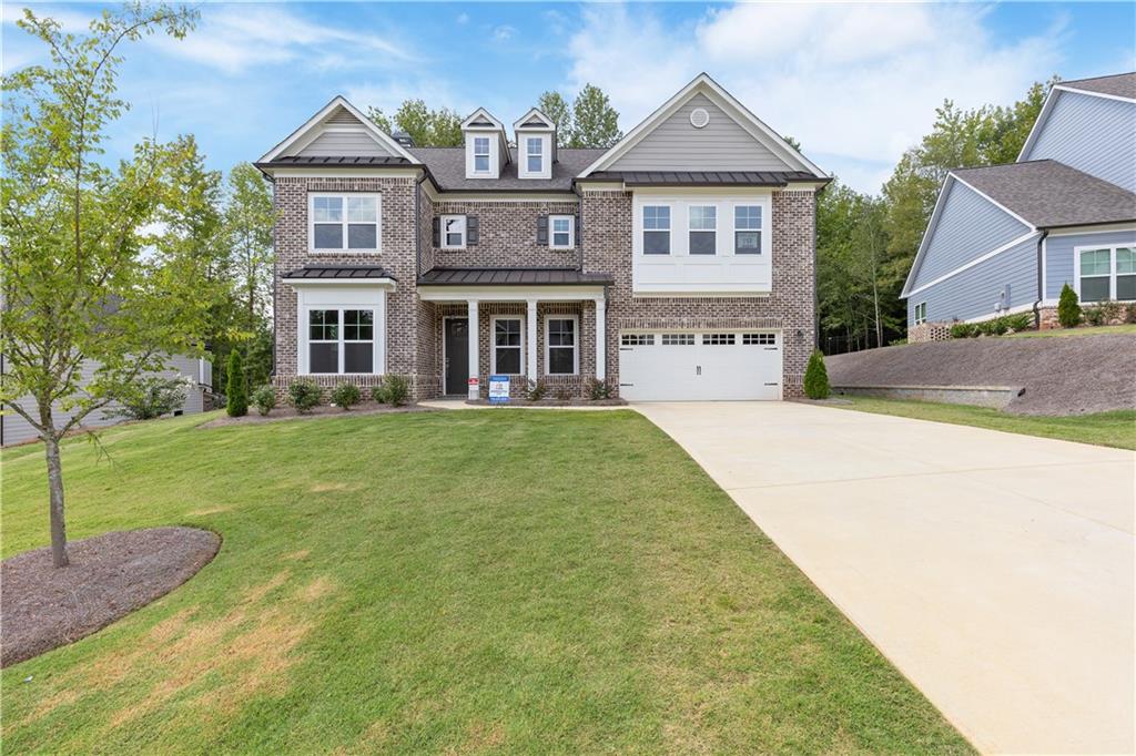a front view of a house with garden