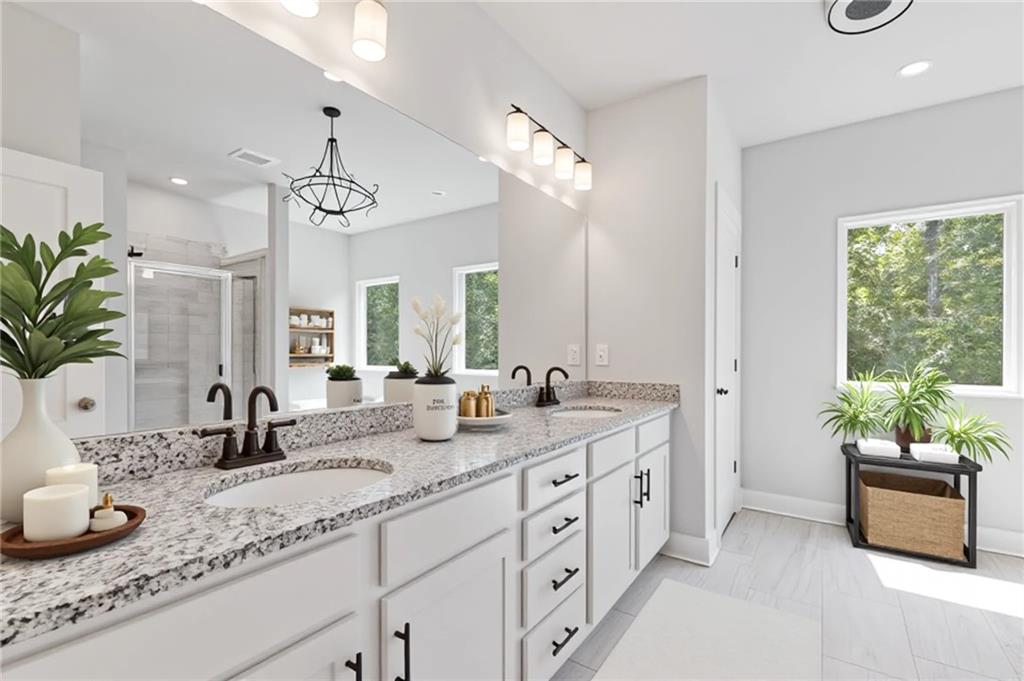 3832 Cheyenne Lane Jefferson, GA 30549 - Photo 10 of 19 a bathroom with double vanity sinks a large mirror and a shower