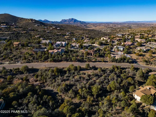 an aerial view of residential houses with city view