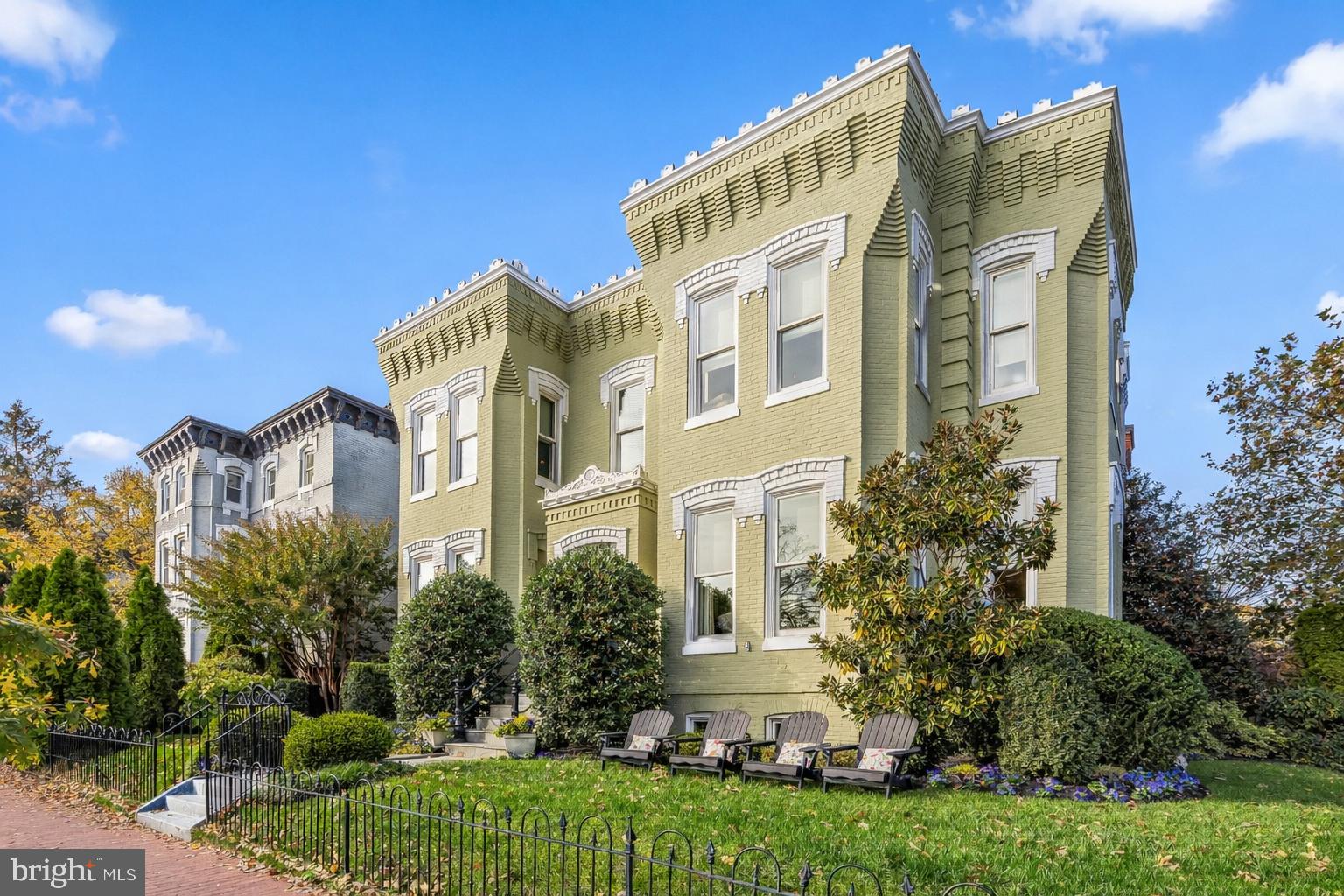 a front view of a residential apartment building with a yard