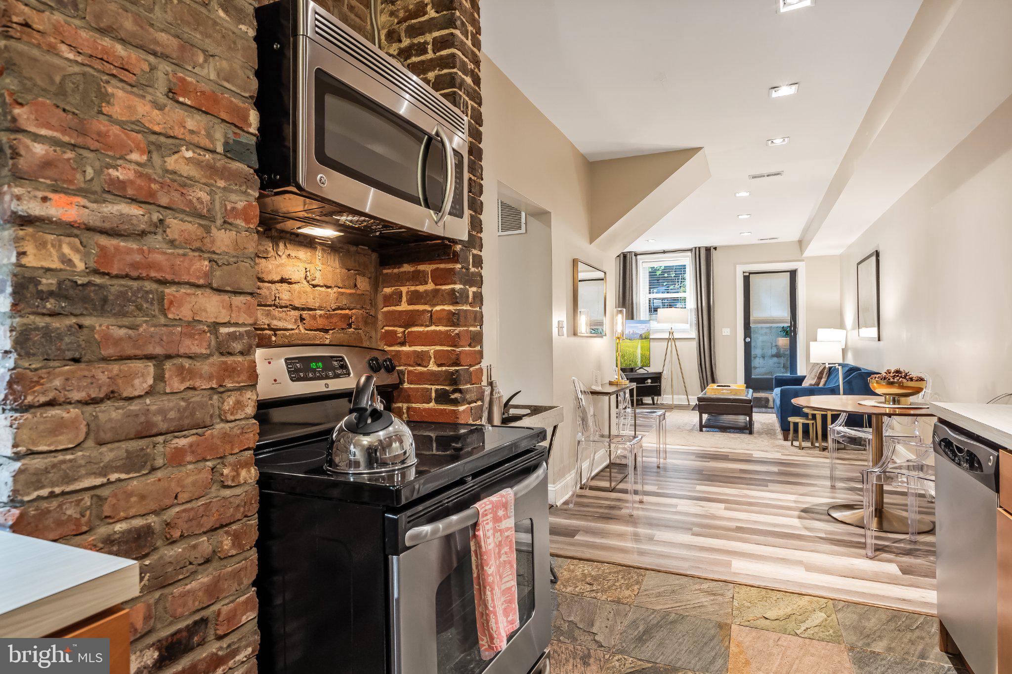 1740 13th Street Northwest Washington, DC 20009 - Photo 69 of 82 a kitchen with granite countertop a stove and a fireplace
