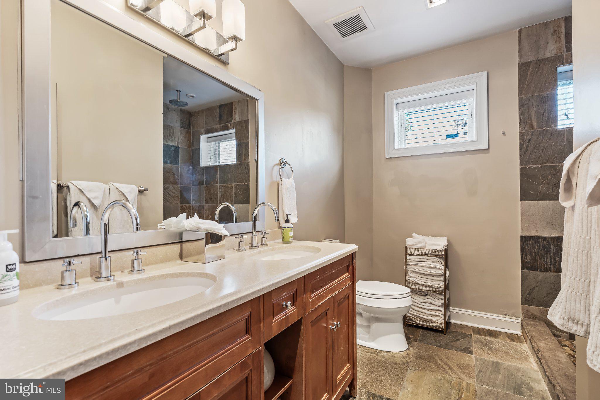 1740 13th Street Northwest Washington, DC 20009 - Photo 76 of 82 a bathroom with a double vanity sink toilet and a mirror