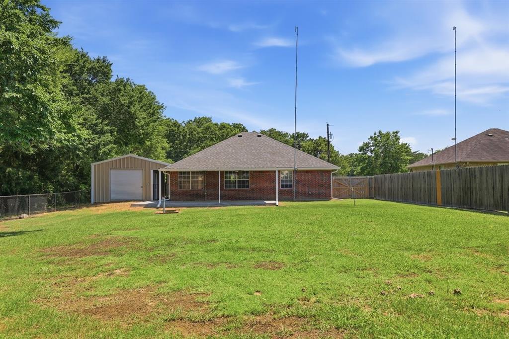 1974 County Road Powderly, TX 75473 - Photo 5 of 28 a house with a big yard