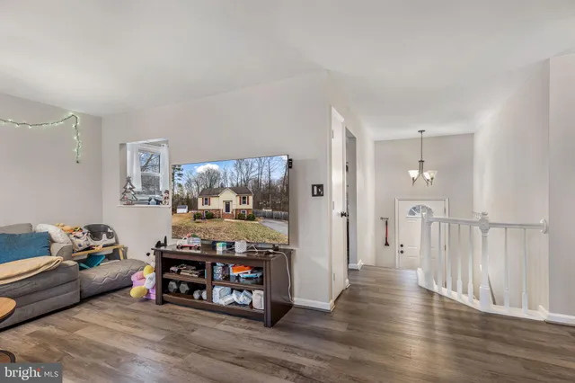 a view of a livingroom with furniture and wooden floor