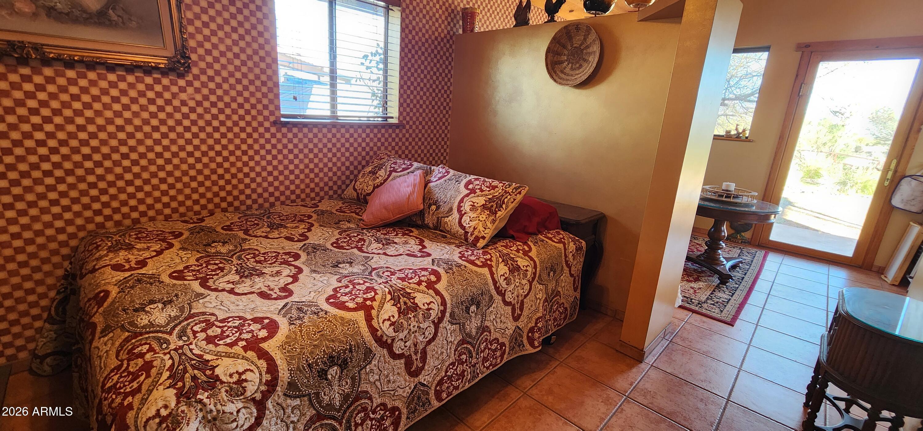 27675 State Highway 89 Congress, AZ 85332 - Photo 14 of 18 a bedroom with a bed and wooden floor