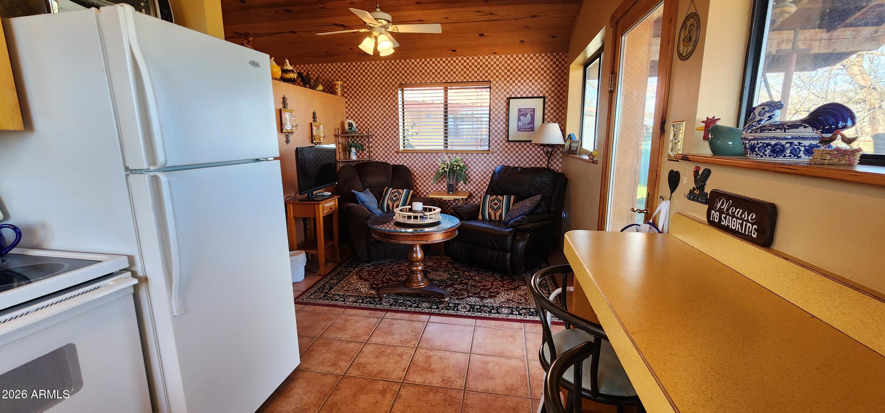 27675 State Highway 89 Congress, AZ 85332 - Photo 16 of 18 a living room with furniture and a refrigerator