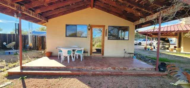 a patio with glass top table and chairs