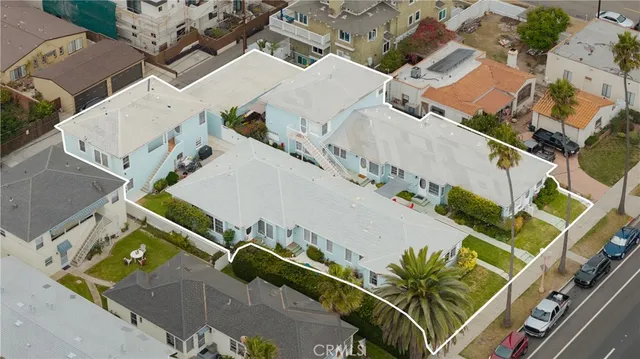 an aerial view of a house with outdoor space and street